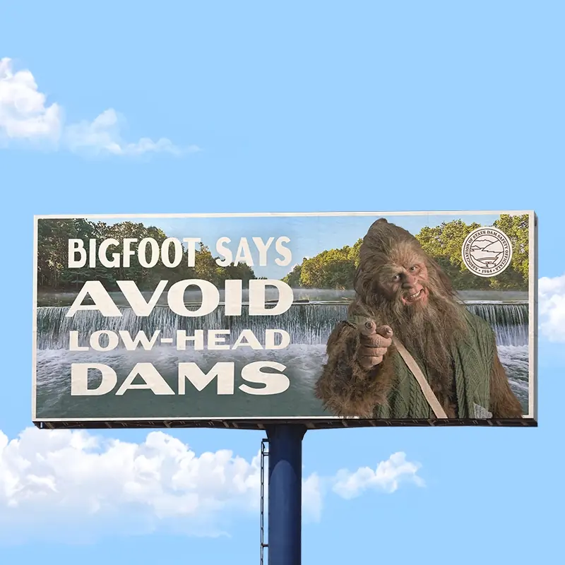 Billboard advertisement featuring Bigfoot promoting dam safety awareness